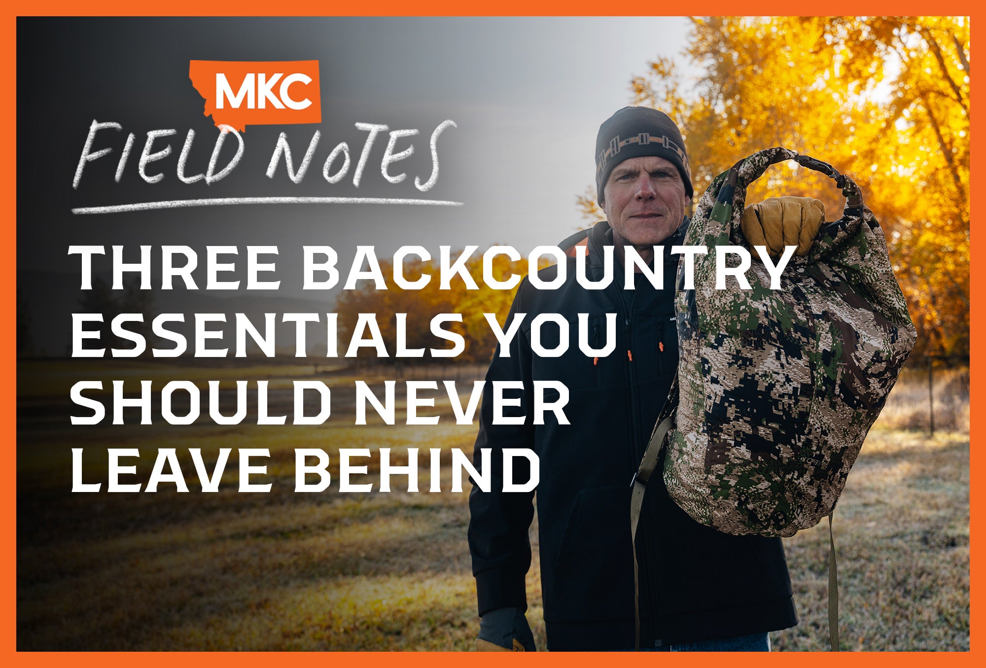 Hunter in black jacket holds camouflage gear bag outdoors with fall foliage.
