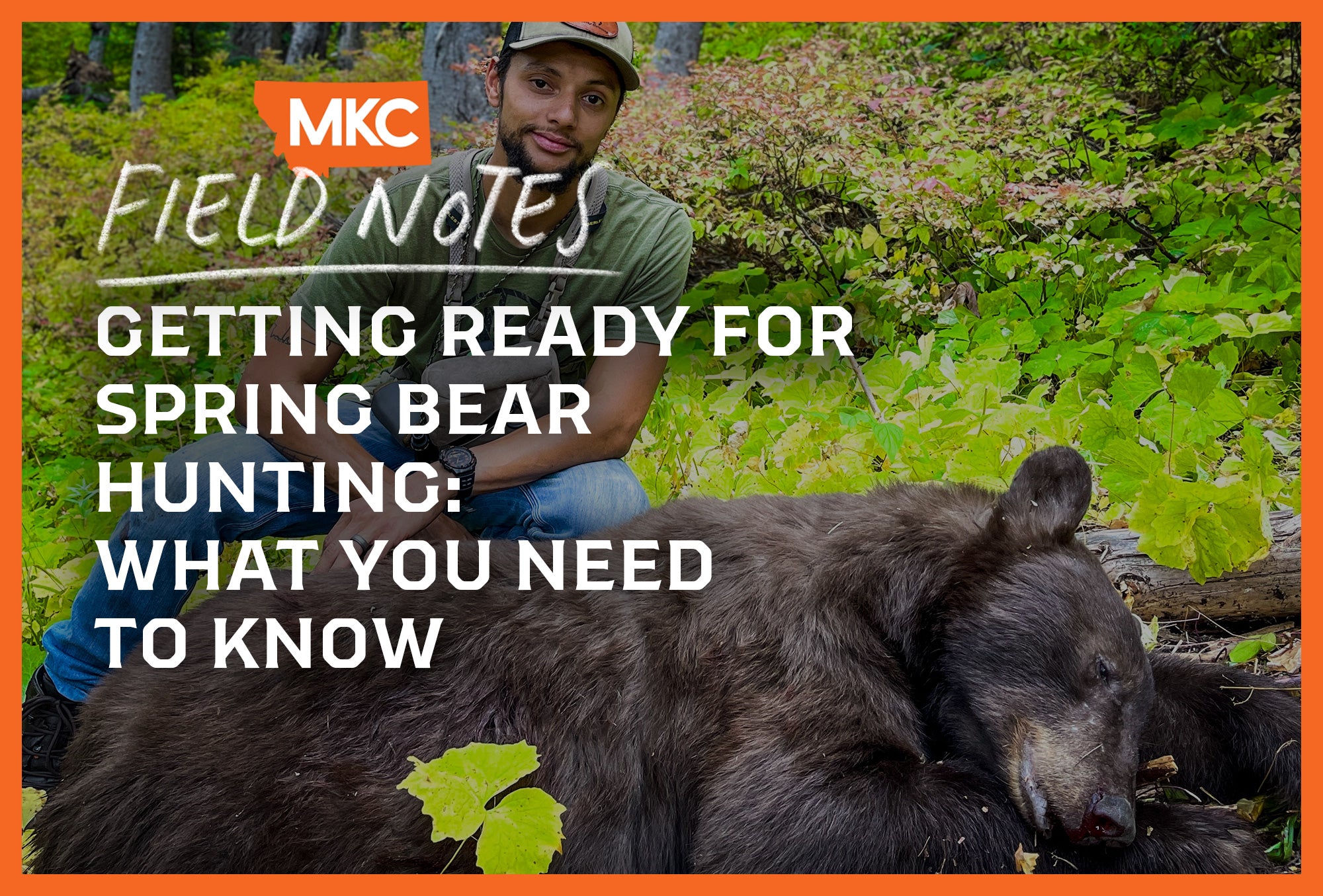 A man kneels behind his kill in the field after a successful outing of spring bear hunting.