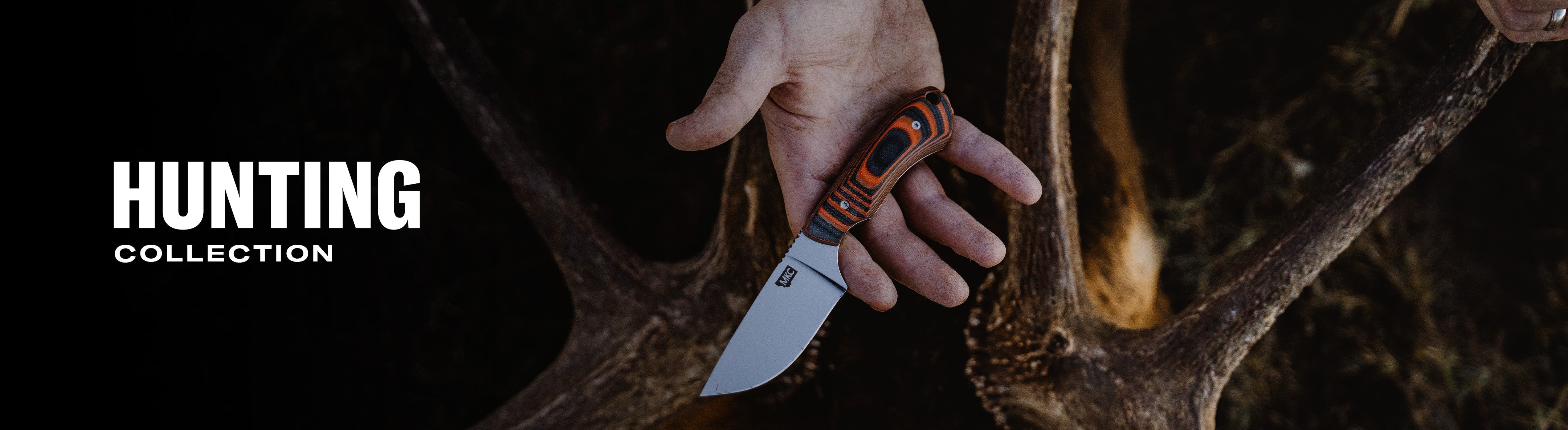 A hand holding a Montana Knife Company hunting knife against a backdrop of deer antlers, showcasing the HUNTING collection.