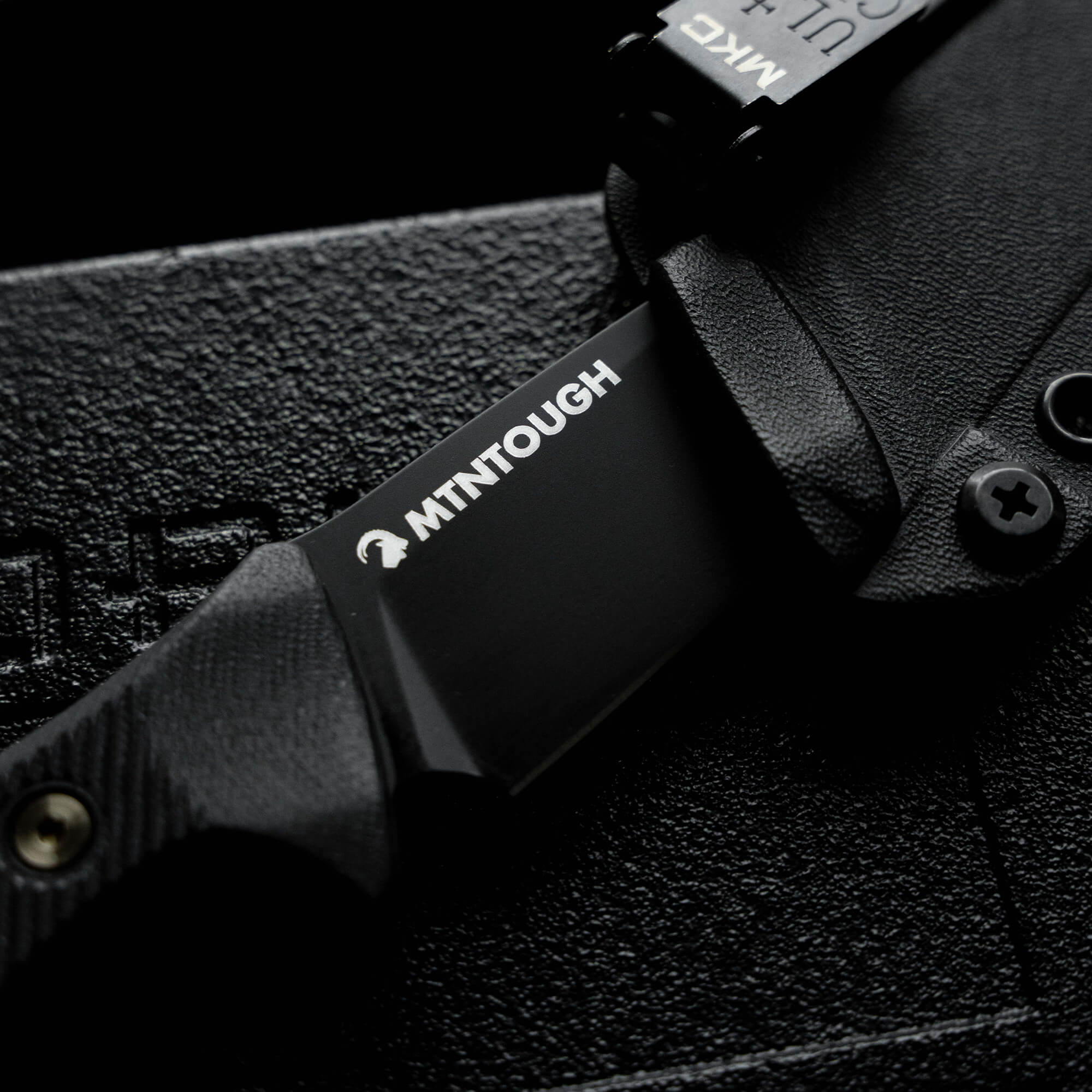 MTNTOUGH TF24 knife showcasing a sleek black blade and textured handle, designed for durability and performance.