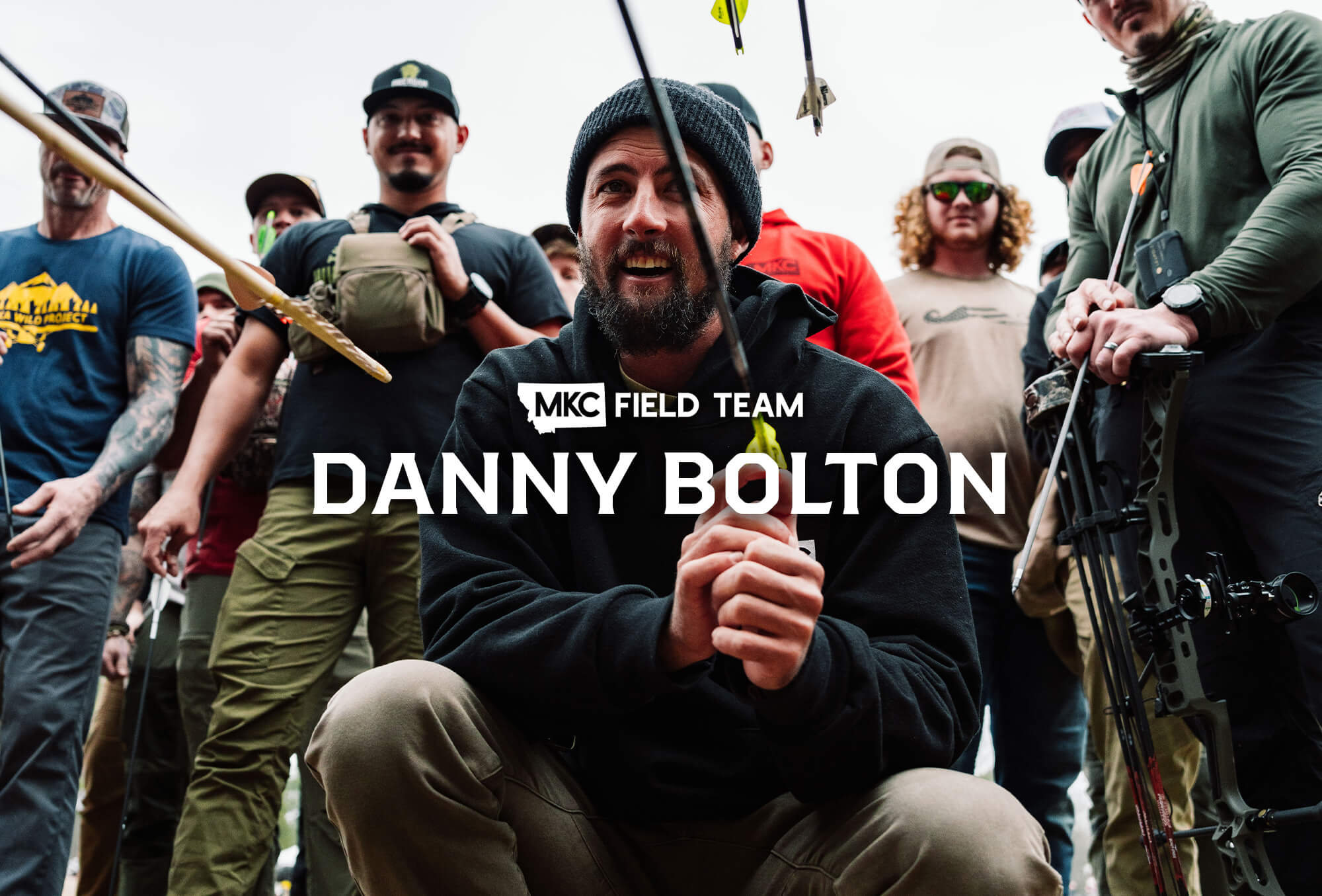 Adventurer Danny Bolton draws an arrow on his compound bow as he looks into the distance.