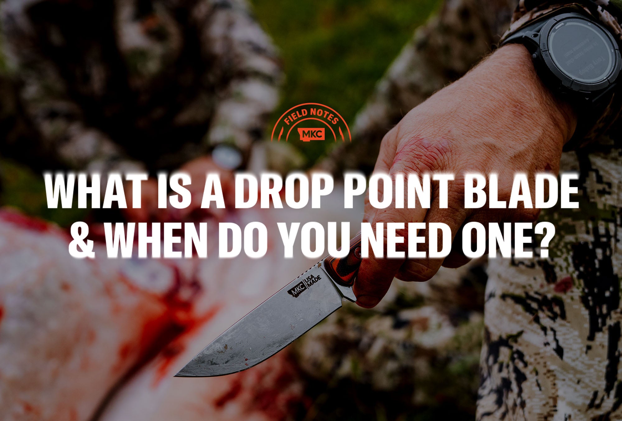 Close‑up of a hand gripping an MKC drop point knife outdoors.