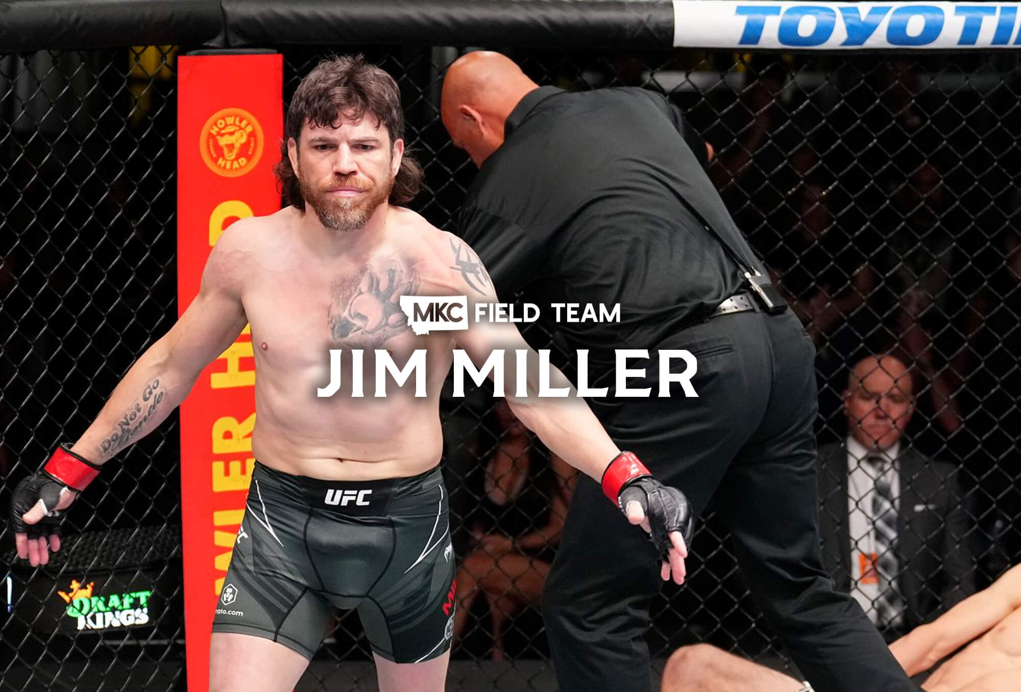 Jim Miller walks forward in a UFC octagon with his opponent down in the background.
