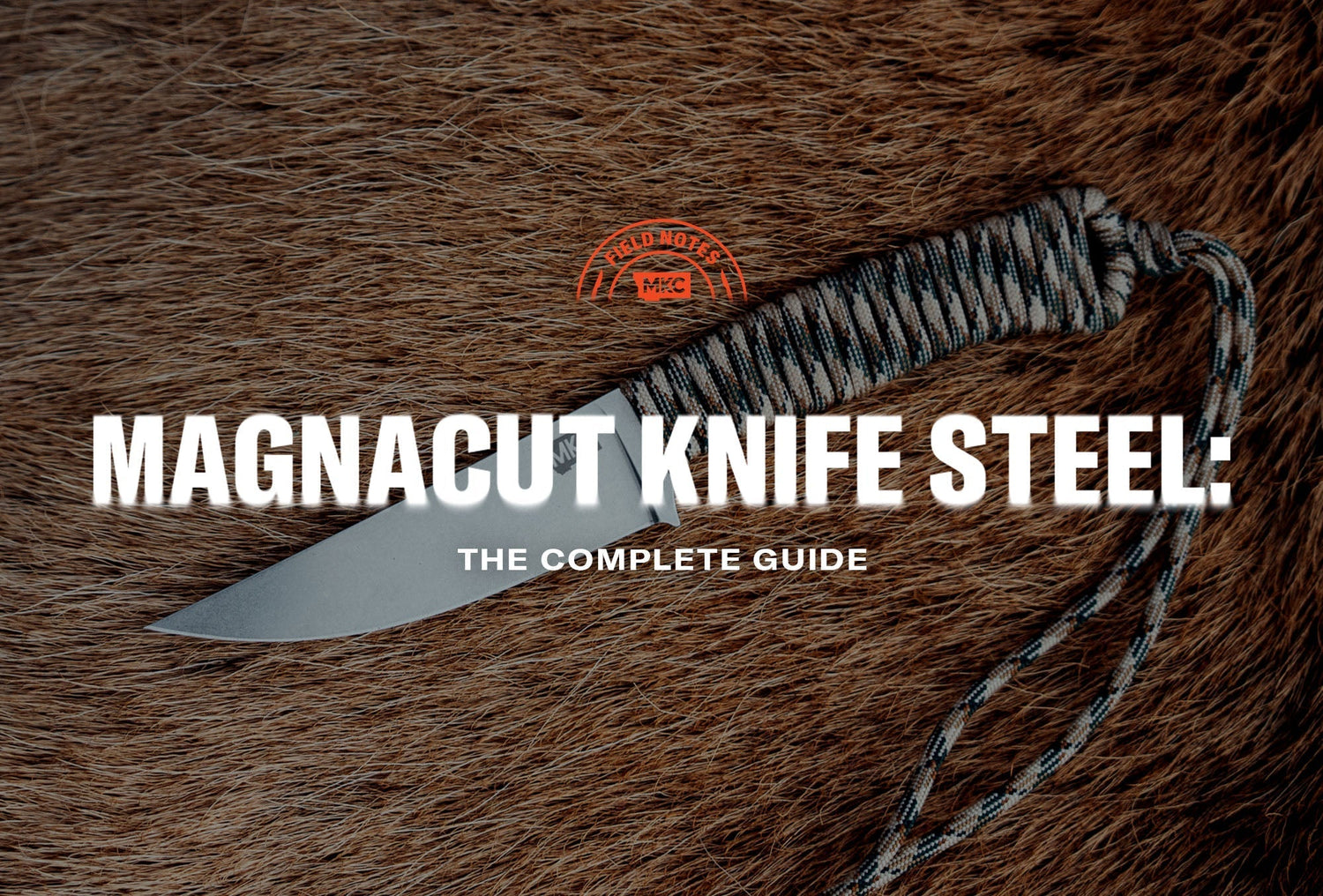MKC Magnacut knife with a paracord-wrapped handle resting on animal hide.