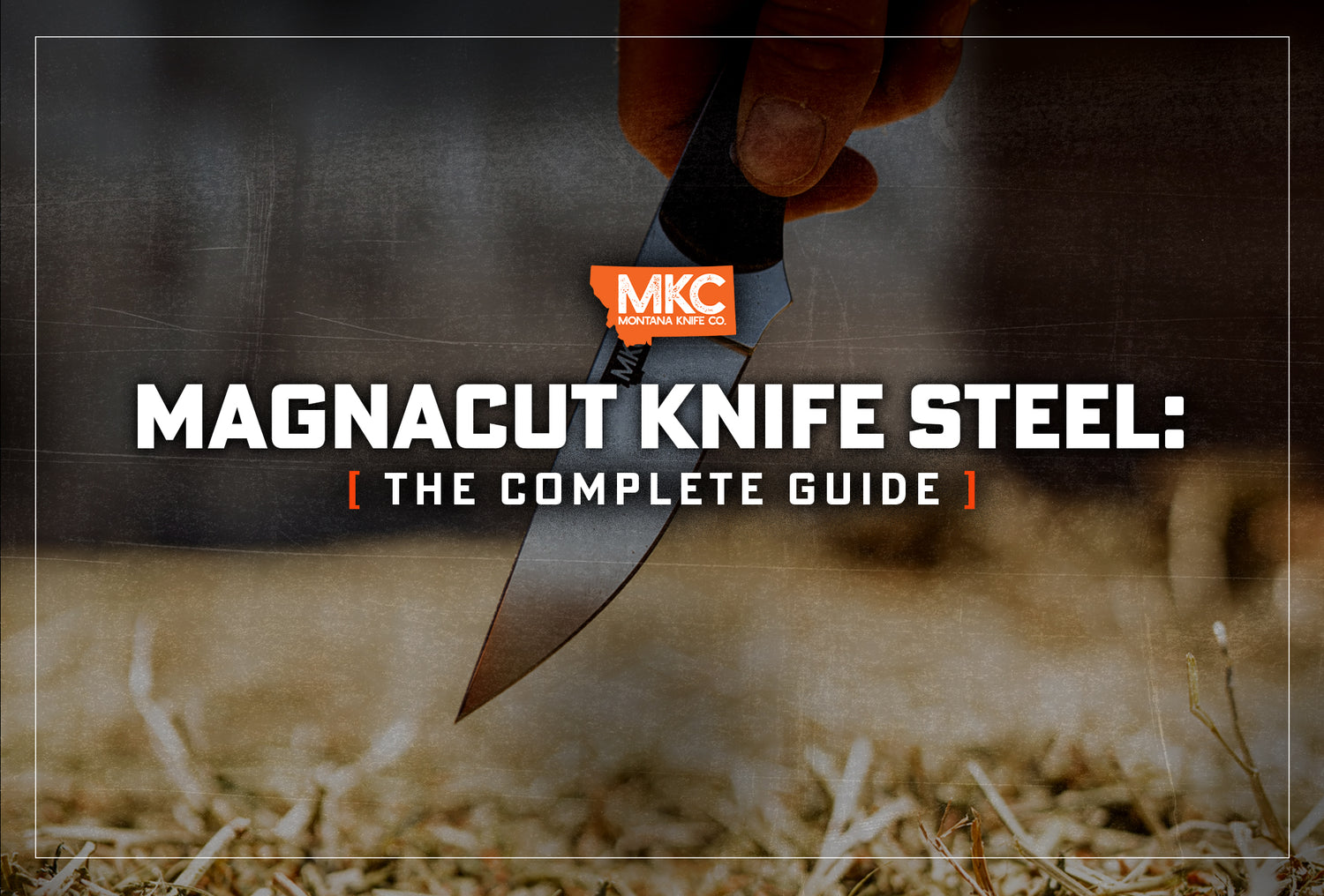 A hand holds a CPM MagnaCut knife with the blade pointed toward the straw-covered ground. 