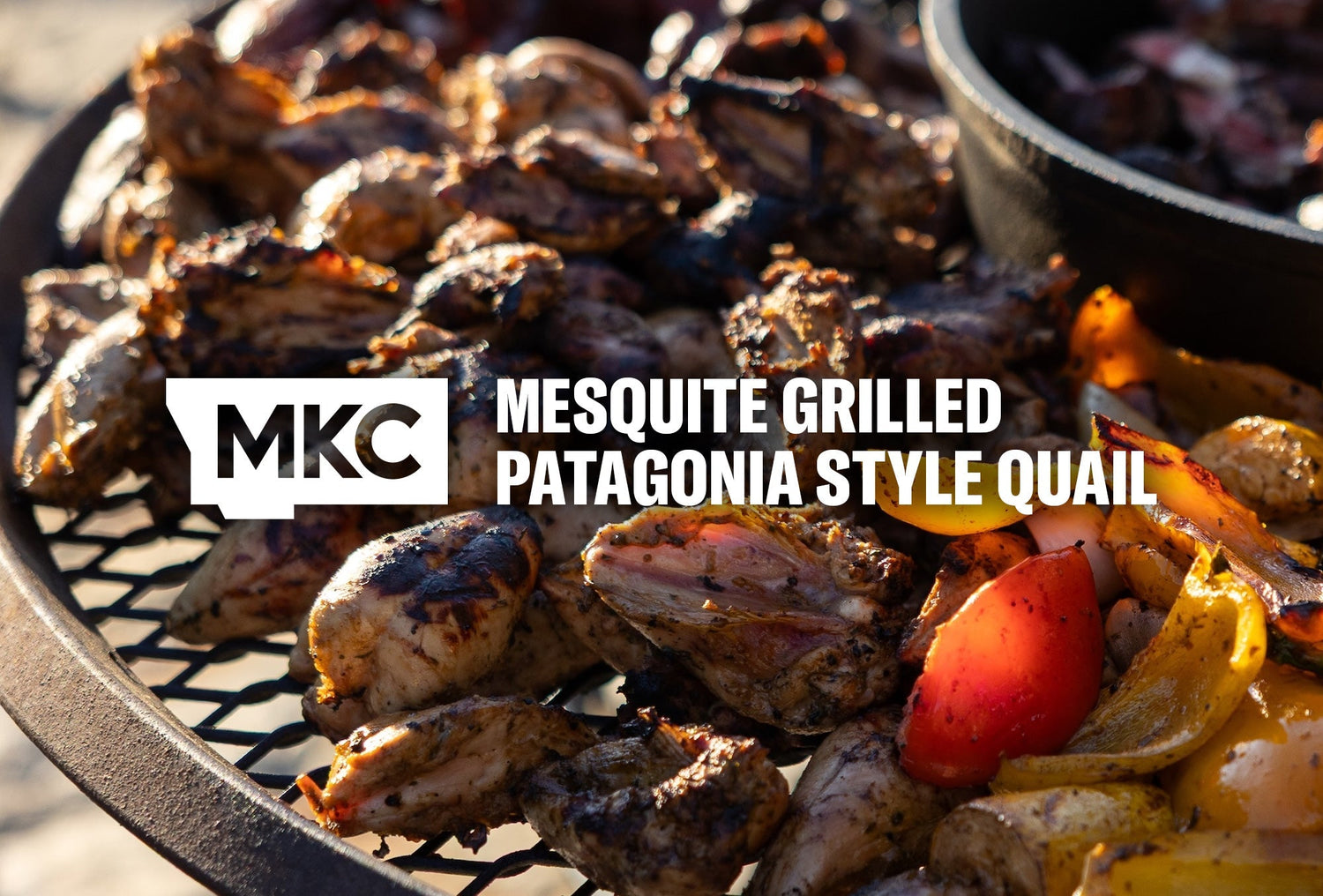 Grilled quail and vegetables cooking over open mesquite coals, showing charred skin and smoky color.