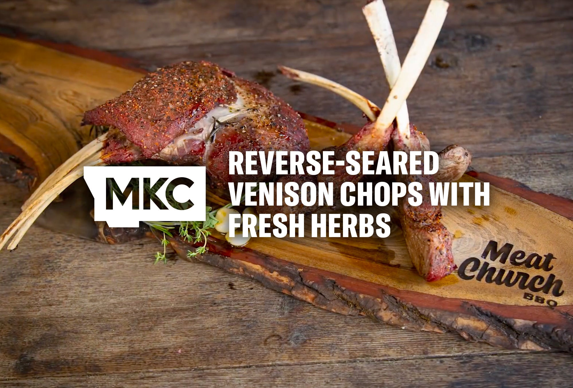 Reverse‑seared venison chops resting on a wooden surface, showing a browned crust and fresh herb garnish.