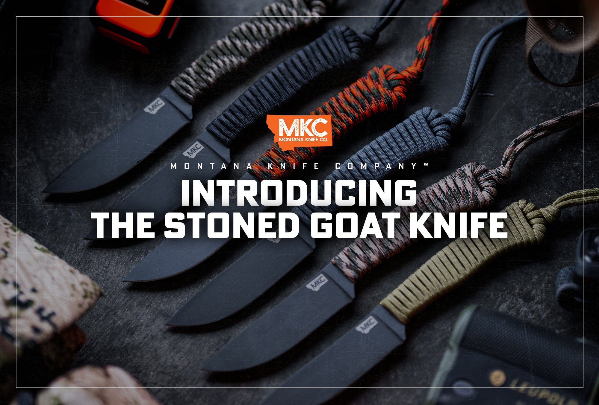 Six MKC Stoned Goat blades with varying paracord handle colors lie at an angle on a dark background.