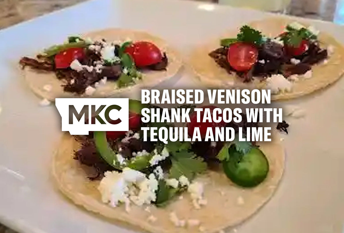 Three venison shank tacos in corn tortillas topped with crisped meat, jalapeños, tomatoes, queso fresco, and cilantro.