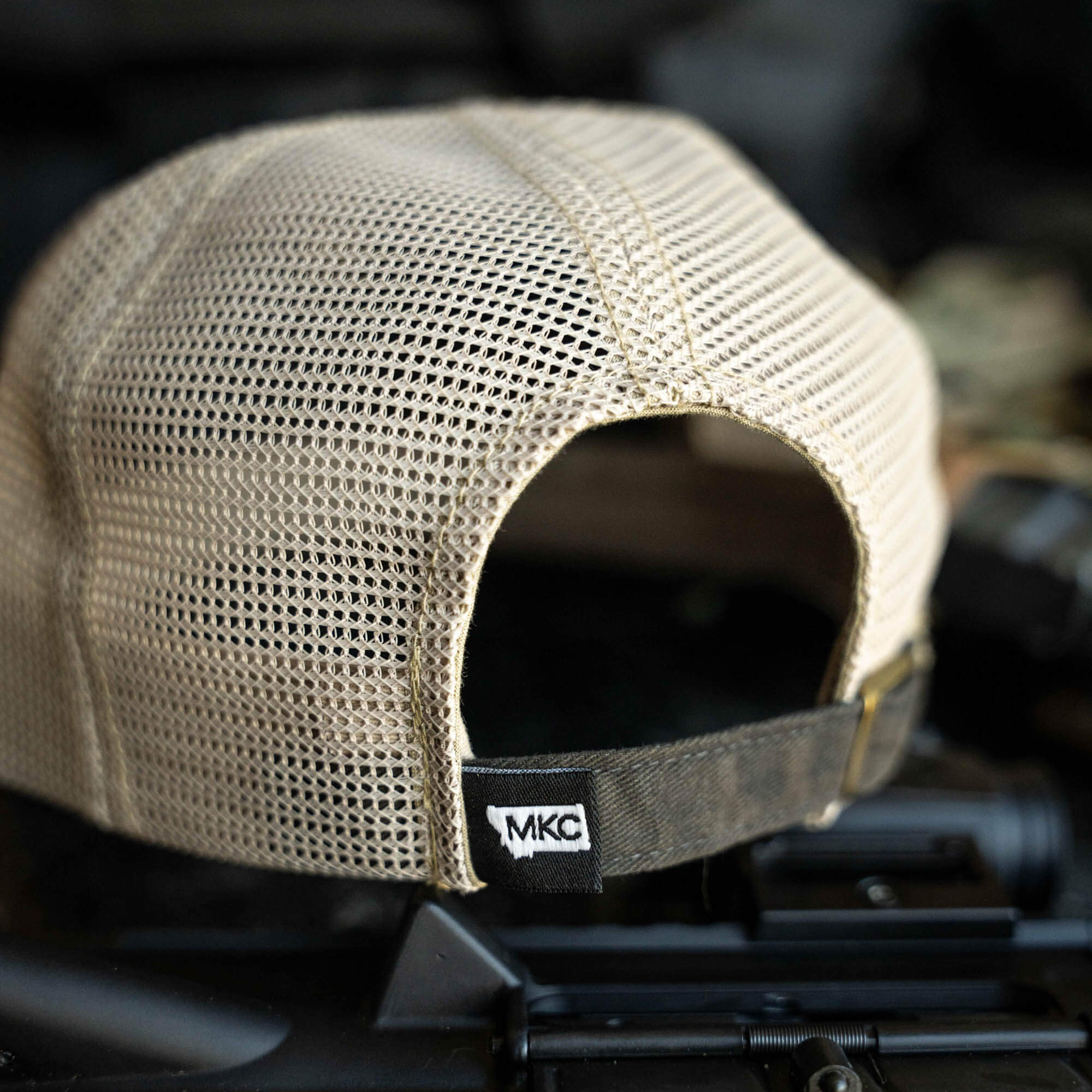 Back view of the MKC Tactical Classic Trucker hat featuring a mesh design and MKC logo, ideal for outdoor use.