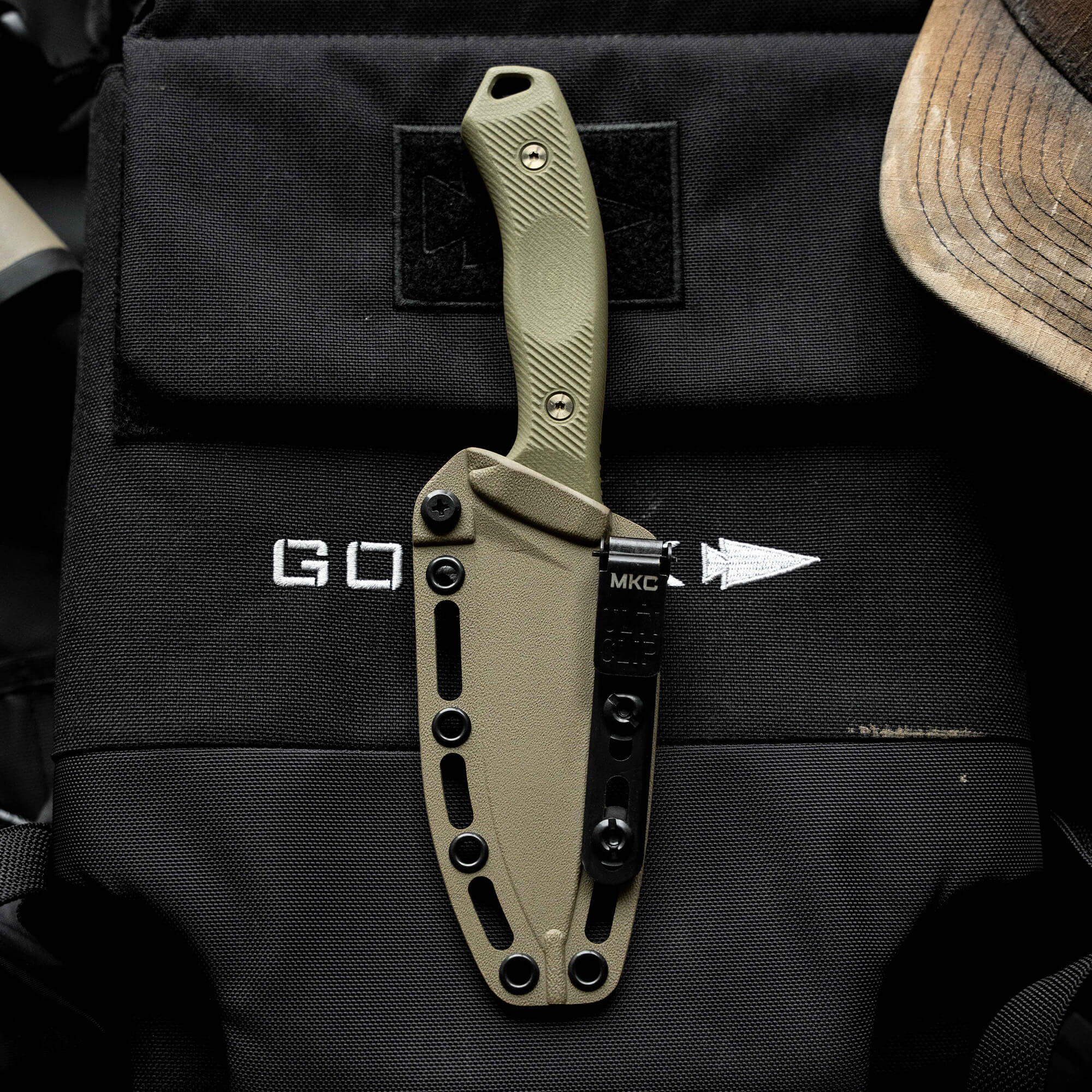 MTNTOUGH TF24 knife with a green handle and sheath, designed for durability and performance in outdoor tasks.