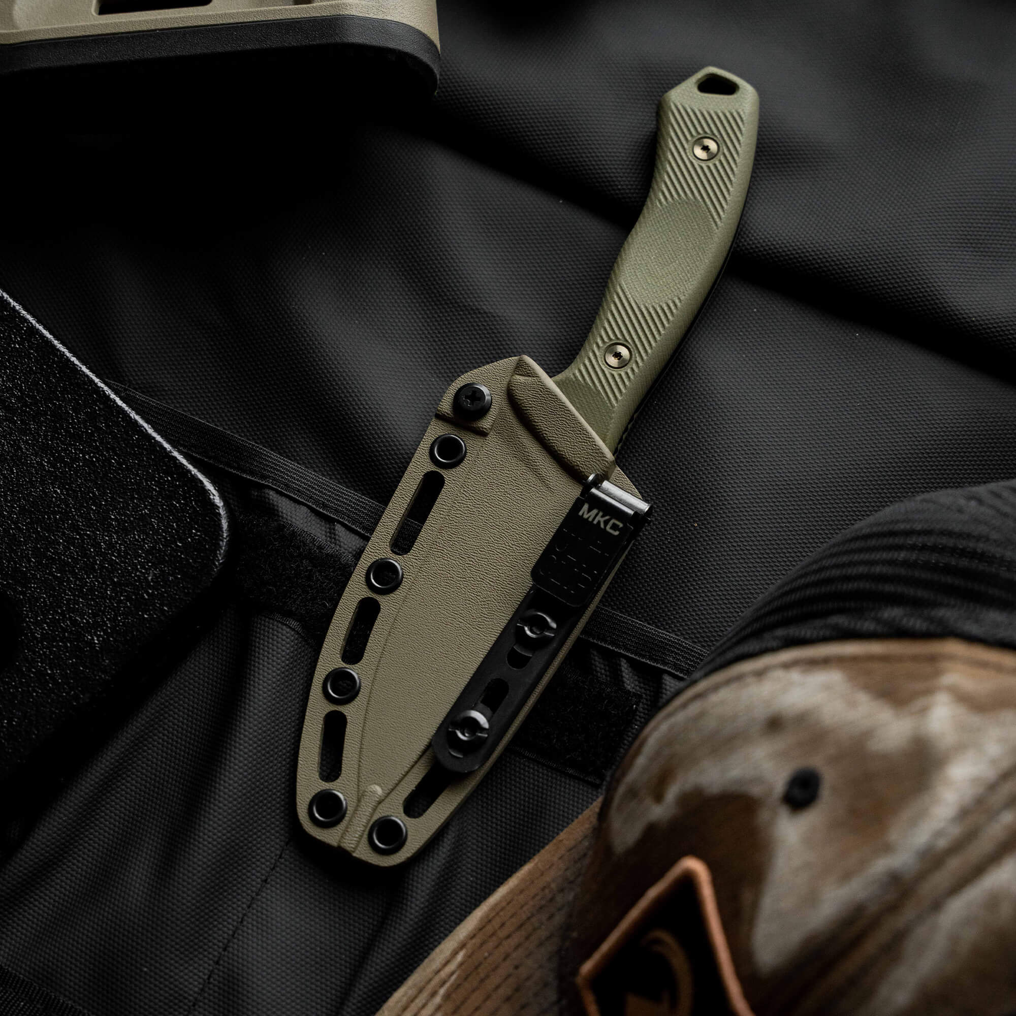 MTNTOUGH TF24 knife with a green handle and sheath, designed for outdoor use and rugged tasks.